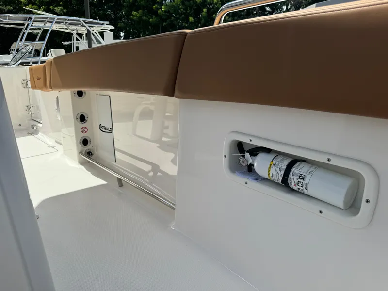 Slide: The Image of 2025 Robalo R250 Center Console boat interior with fire extinguisher and cushioned seating. - 25