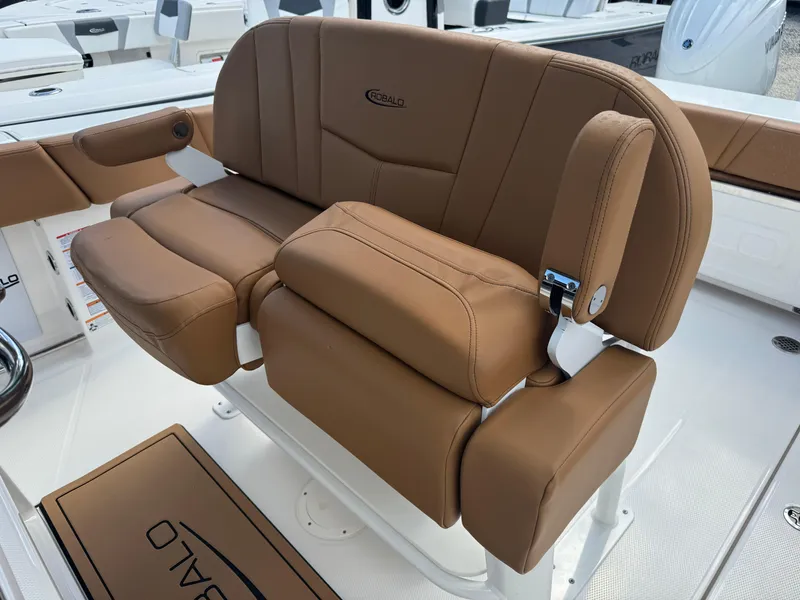 Slide: The Image of 2025 Robalo R250 Center Console boat with brown cushioned seating. - 27