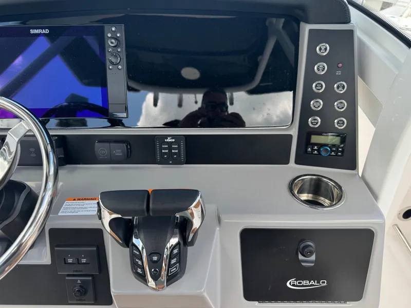 Slide: The Image of 2025 Robalo R250 Center Console dashboard with controls and Simrad display. - 28