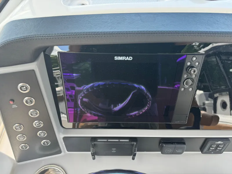 Slide: The Image of 2025 Robalo R250 Center Console dashboard with Simrad display and control panel. - 31