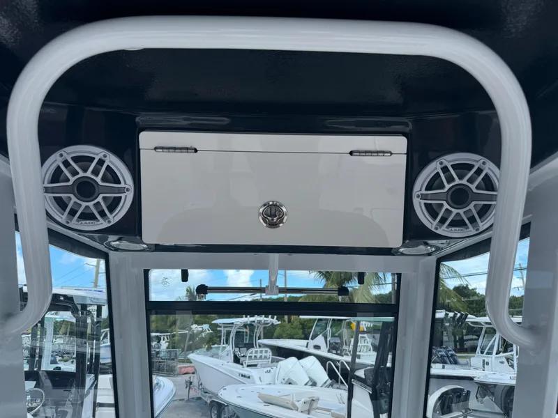 Slide: The Image of 2025 Robalo R250 Center Console boat interior with speakers and storage compartment. - 7