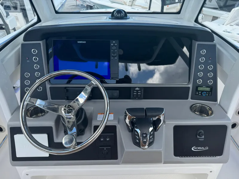 Slide: The Image of 2025 Robalo R250 Center Console dashboard with steering wheel and navigation controls. - 8