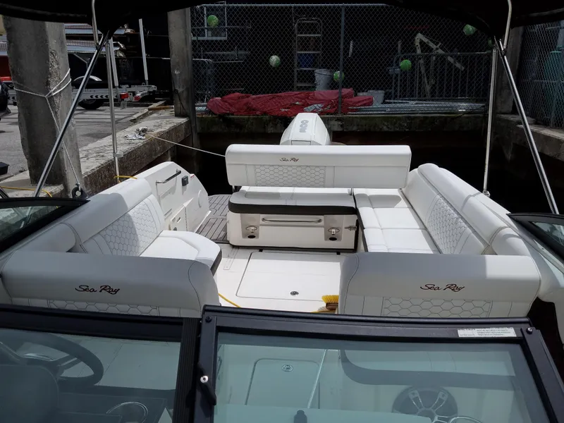 Slide: The Image of 2022 Sea Ray SDX 250 Outboard boat interior with white seating and spacious layout. - 21