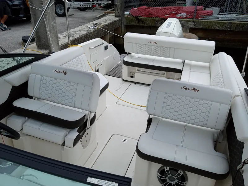 Slide: The Image of 2022 Sea Ray SDX 250 Outboard interior with white seating and modern design. - 23