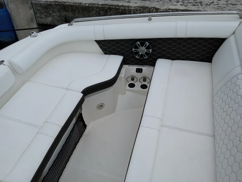 Slide: The Image of 2022 Sea Ray SDX 250 Outboard interior with white seating and speaker system. - 24
