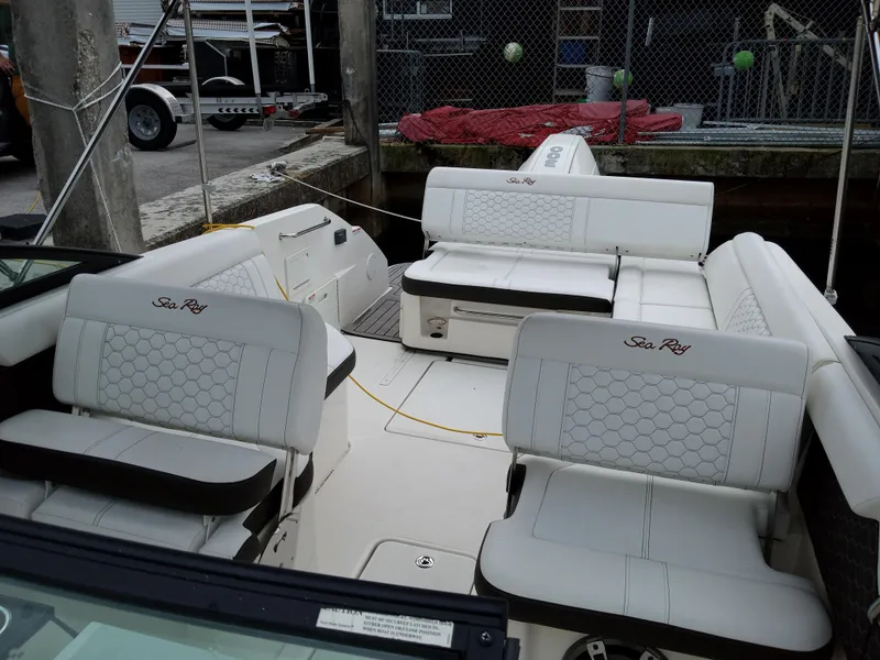 Slide: The Image of 2022 Sea Ray SDX 250 Outboard boat interior with white seating and logo. - 25