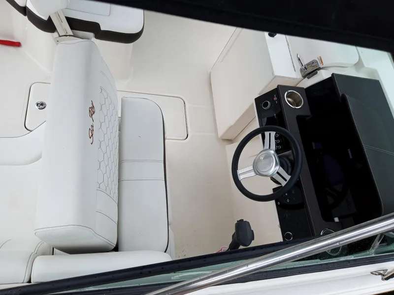 Slide: The Image of 2022 Sea Ray SDX 250 Outboard interior with white seating and steering wheel. - 29