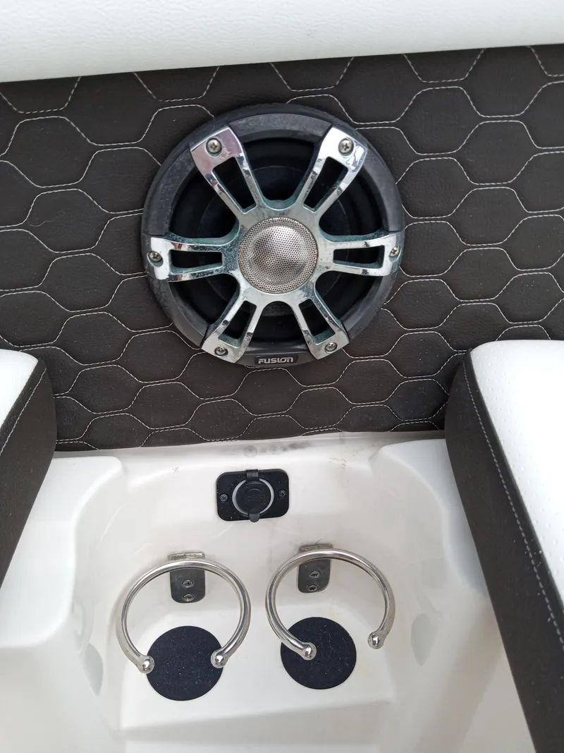 Slide: The Image of 2022 Sea Ray SDX 250 Outboard speaker and cup holders on hex-patterned interior. - 43