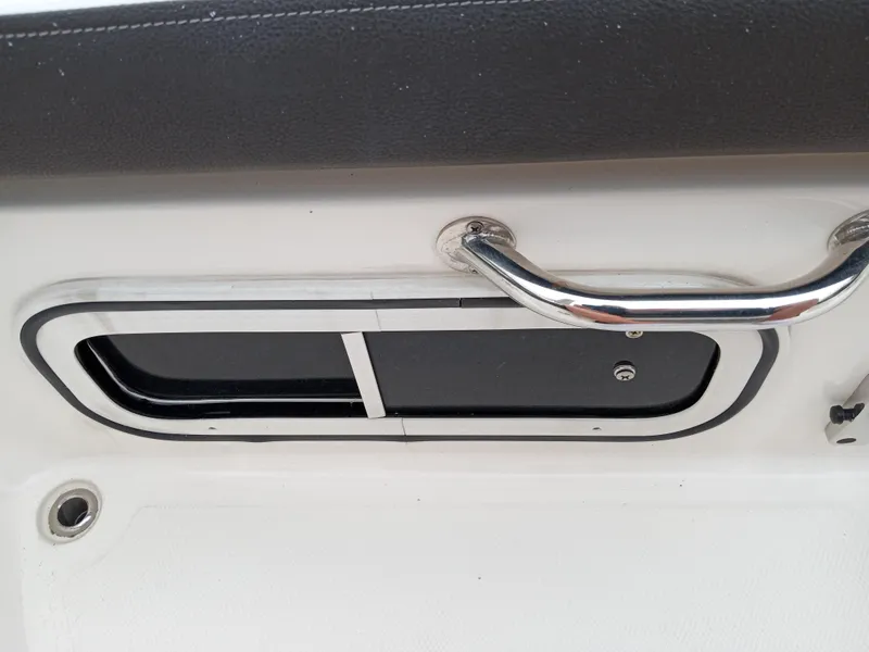 Slide: The Image of 2022 Sea Ray SDX 250 Outboard boat handle and compartment detail. - 44