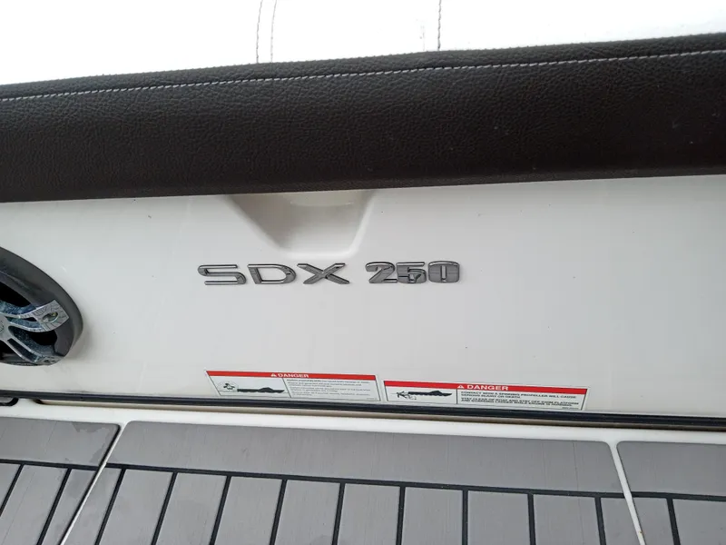 Slide: The Image of 2022 Sea Ray SDX 250 Outboard boat interior detail with logo and flooring. - 47