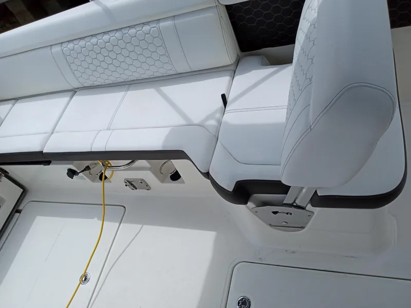 Slide: The Image of 2022 Sea Ray SDX 250 Outboard interior with white seating and modern design. - 9