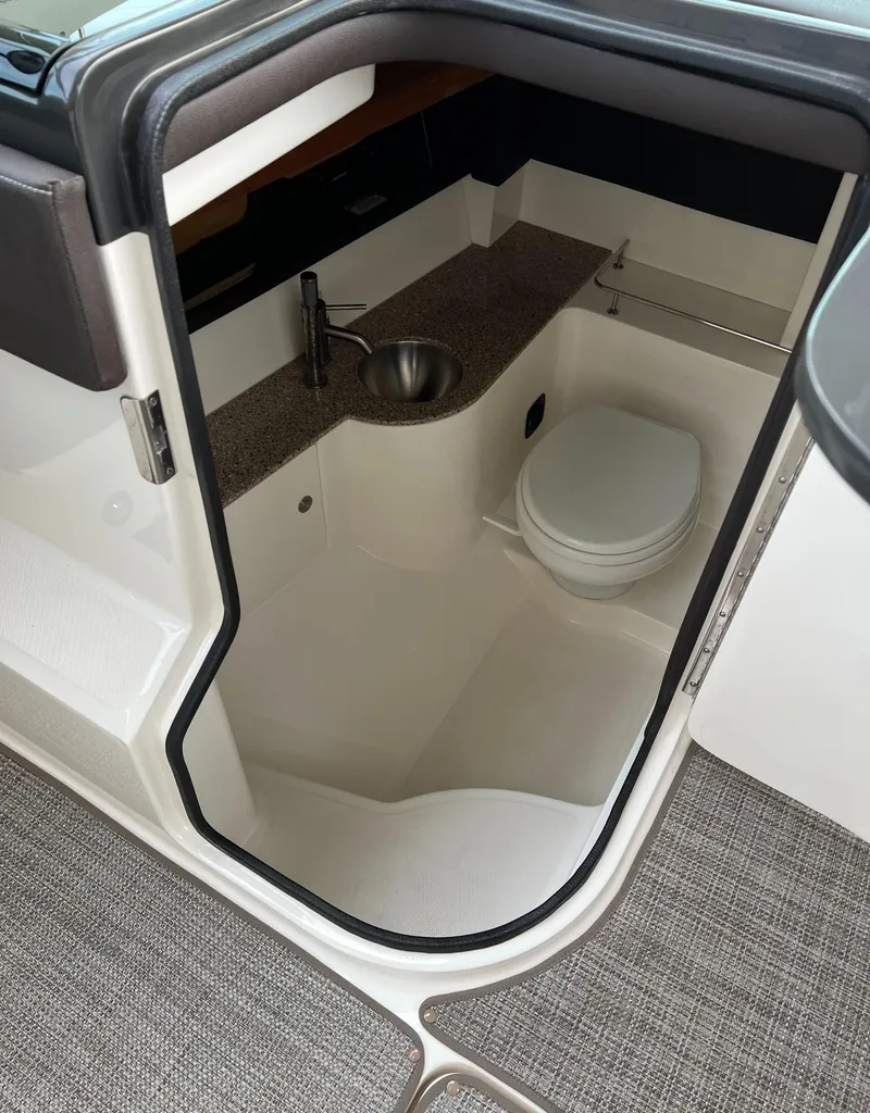 Slide: The Image of 2016 Sea Ray 350 SLX boat interior bathroom with sink and toilet. - 11