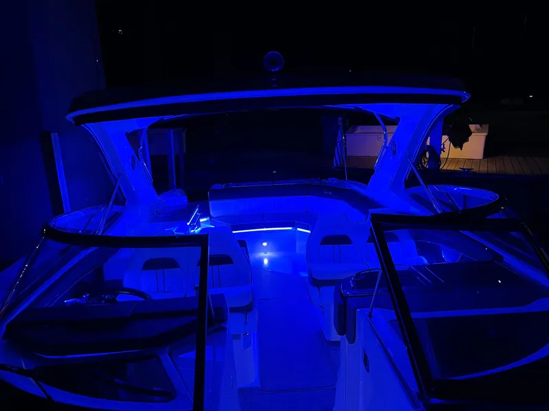 Slide: The Image of 2016 Sea Ray 350 SLX boat with blue interior lighting at night. - 13
