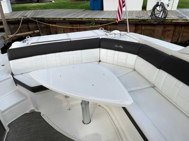Slide: The Image of 2016 Sea Ray 350 SLX boat interior with white seating and table. - 3