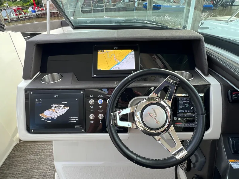 Slide: The Image of 2016 Sea Ray 350 SLX helm with modern navigation displays and sleek steering wheel. - 6