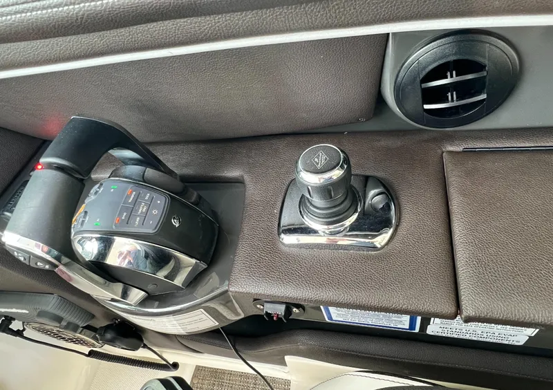 Slide: The Image of 2016 Sea Ray 350 SLX boat controls and joystick on dashboard. - 7
