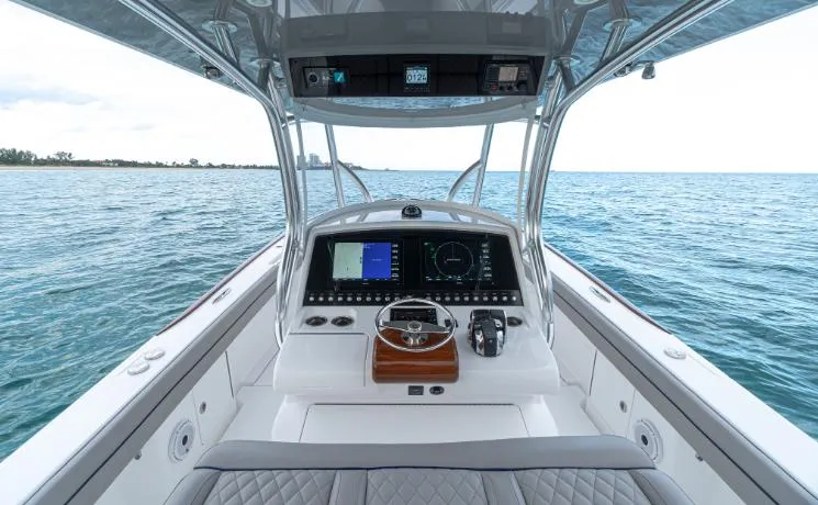Slide: The Image of 2025 Valhalla Boatworks 33 helm with advanced navigation system on open water. - 5