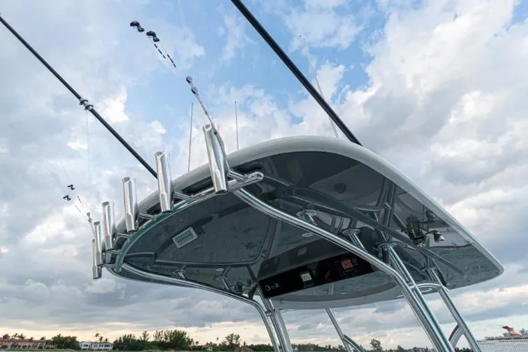 Slide: The Image of Valhalla Boatworks 33 (2025) T-top with fishing rod holders against cloudy sky. - 7