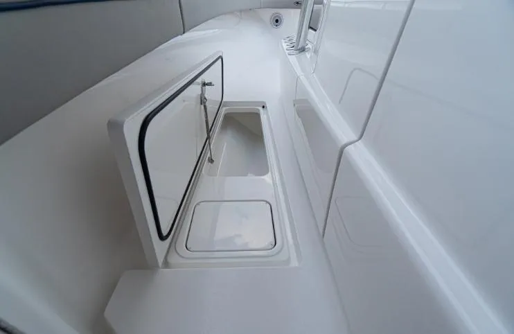 Slide: The Image of 2025 Valhalla Boatworks 33 interior storage compartment, sleek white design. - 8