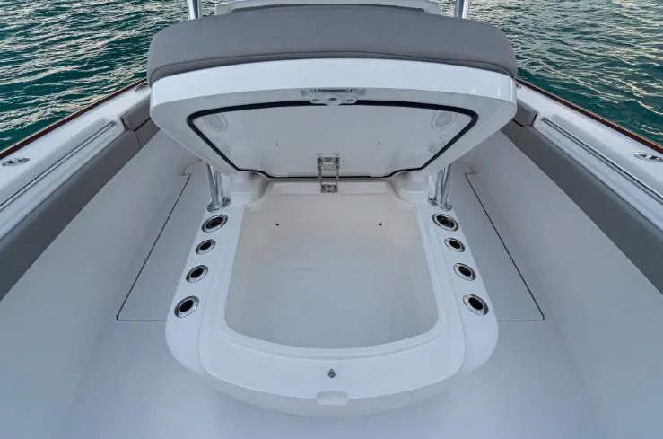Slide: The Image of Open storage compartment on 2025 Valhalla Boatworks 33, surrounded by water. - 9