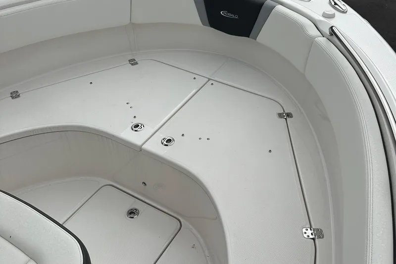 Slide: The Image of 2025 Robalo R222 Center Console boat interior with white seating and storage compartments. - 10