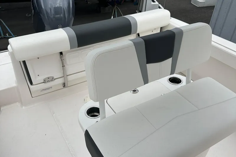 Slide: The Image of 2025 Robalo R222 Center Console boat interior with cushioned seating and cup holders. - 11