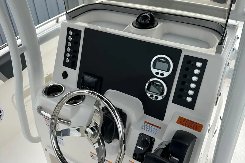 Slide: The Image of 2025 Robalo R222 Center Console dashboard with steering wheel and controls. - 6