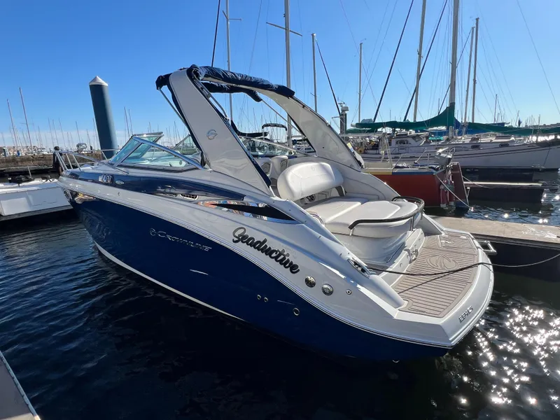 Slide: The Image of 2020 Crownline 264 CR boat docked in marina, sunny day. - 2