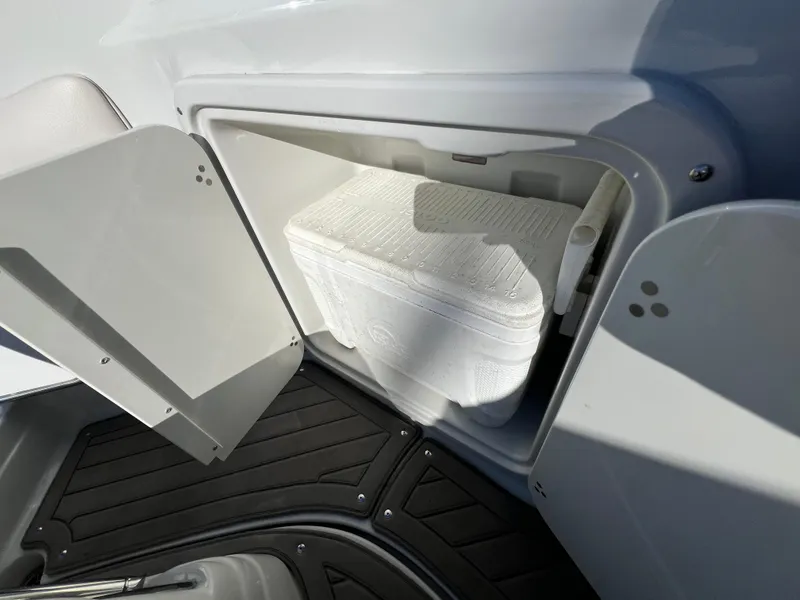Slide: The Image of Crownline 264 CR 2020 boat storage compartment with cooler inside. - 22