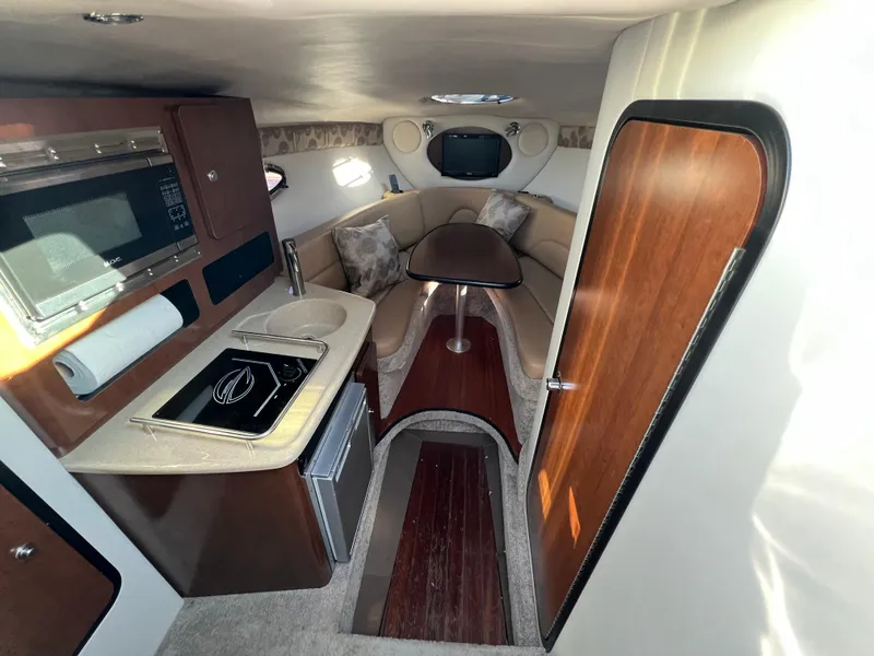 Slide: The Image of 2020 Crownline 264 CR cabin interior with kitchenette and seating area. - 28