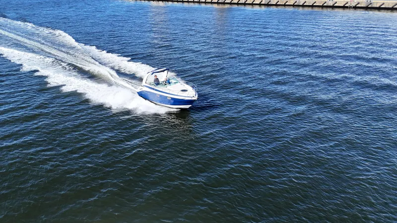 Slide: The Image of 2020 Crownline 264 CR boat cruising on open water. - 3