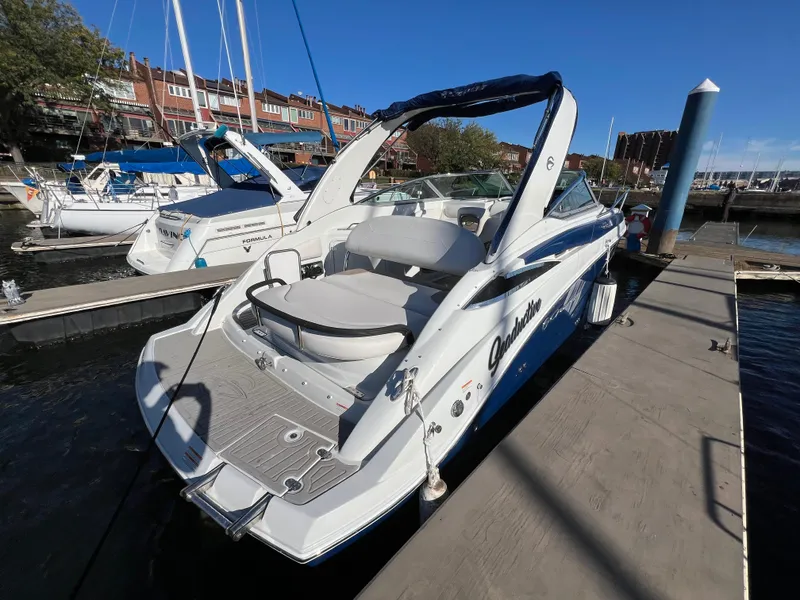 Slide: The Image of 2020 Crownline 264 CR boat docked at marina under clear blue sky. - 5
