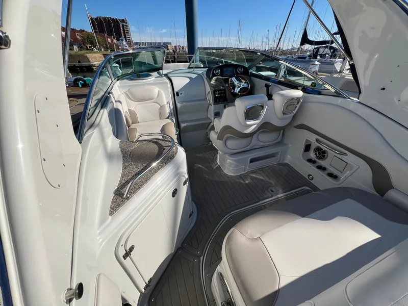 Slide: The Image of 2020 Crownline 264 CR boat interior with modern seating and dashboard. - 9