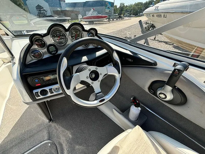 Slide: The Image of Interior view of 2010 Bayliner 215 BR boat dashboard and steering wheel. - 10