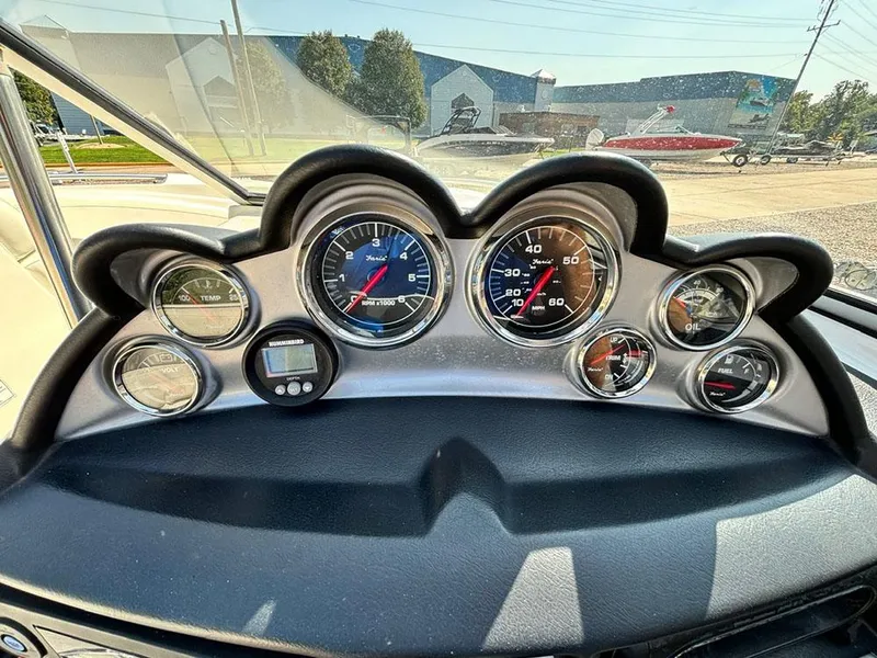 Slide: The Image of Dashboard of a 2010 Bayliner 215 BR boat with multiple gauges and controls. - 11