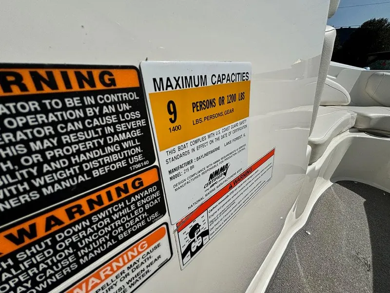 Slide: The Image of 2010 Bayliner 215 BR boat capacity warning label, maximum 9 persons or 1200 lbs. - 15