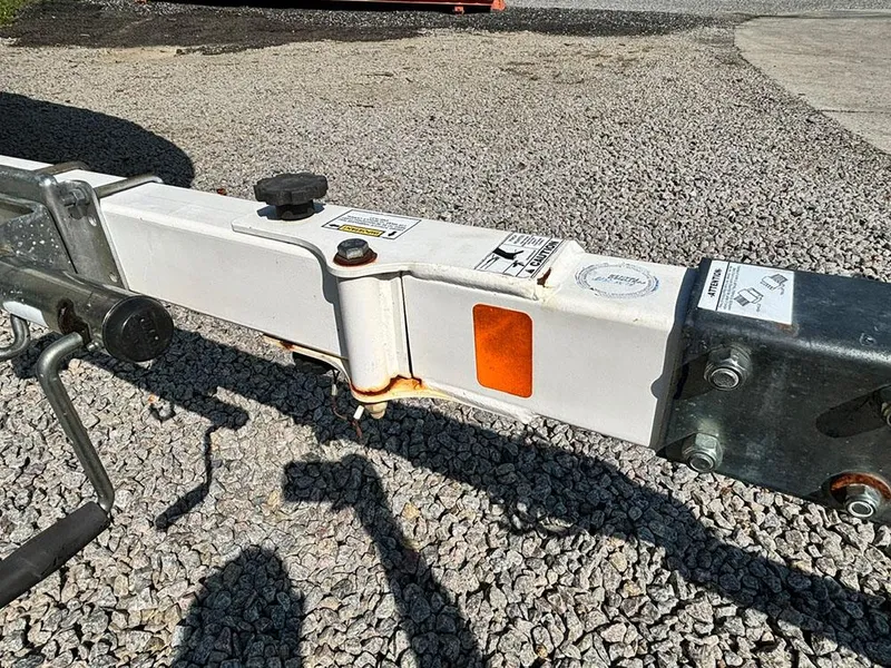 Slide: The Image of Trailer hitch of a 2010 Bayliner 215 BR on gravel surface. - 21