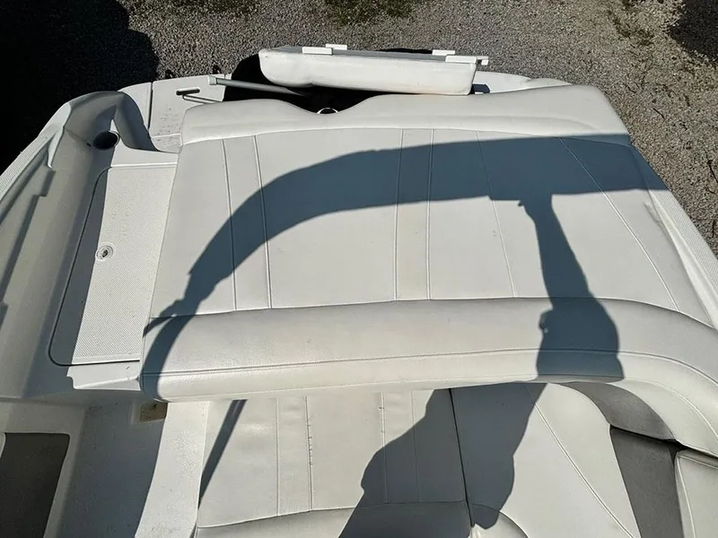 Slide: The Image of 2010 Bayliner 215 BR boat interior with white leather seating and shadow. - 6