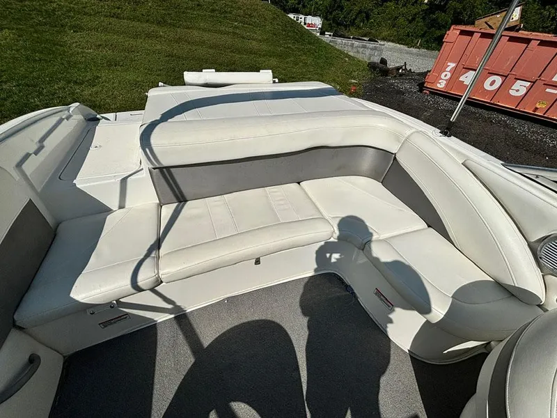 Slide: The Image of 2010 Bayliner 215 BR boat interior with white seating and shadow. - 7