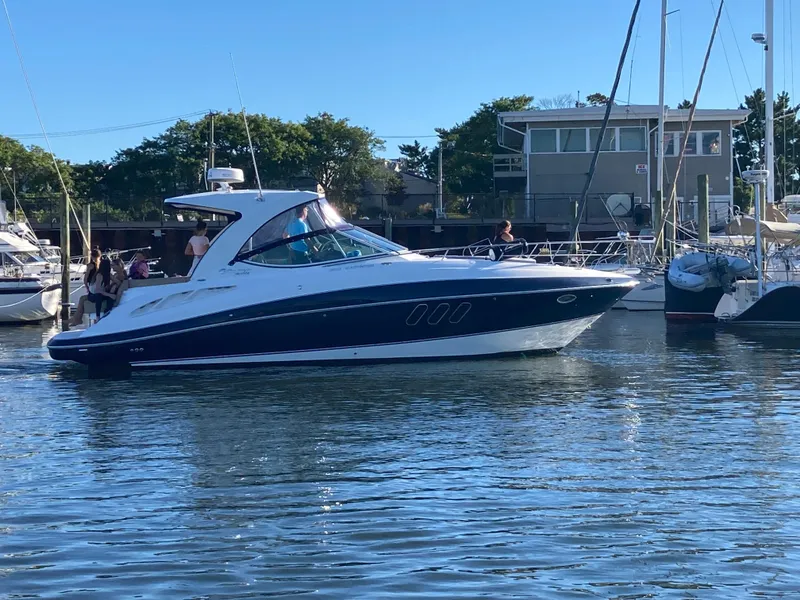 The Image of 2015 Cruisers Yachts 350 Express in marina, sunny day, calm waters. - 0