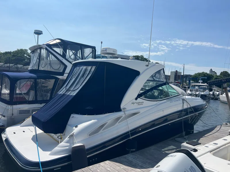 Slide: The Image of 2015 Cruisers Yachts 350 Express docked at marina under clear sky. - 23