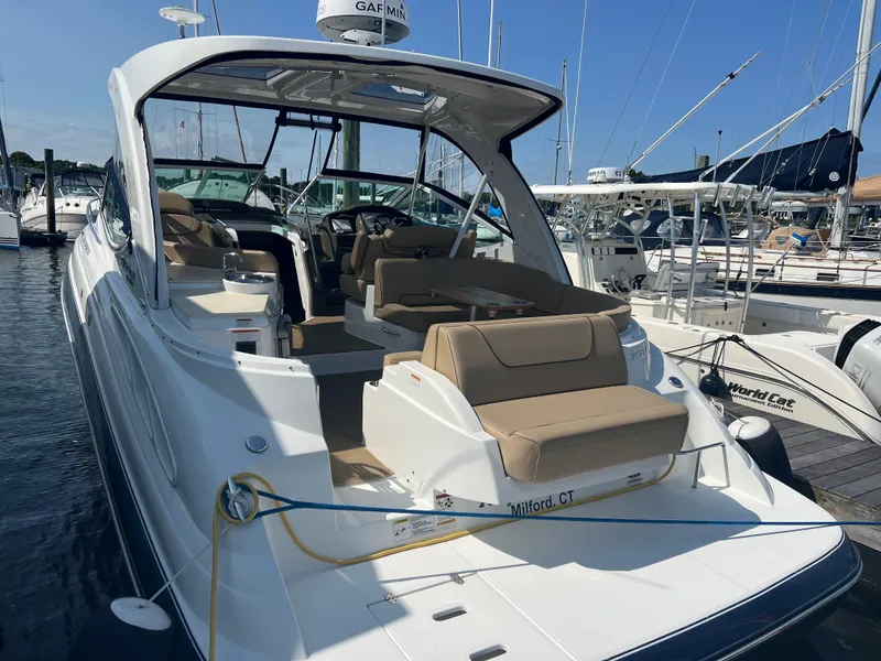 Slide: The Image of 2015 Cruisers Yachts 350 Express docked, featuring spacious seating and sleek design. - 11