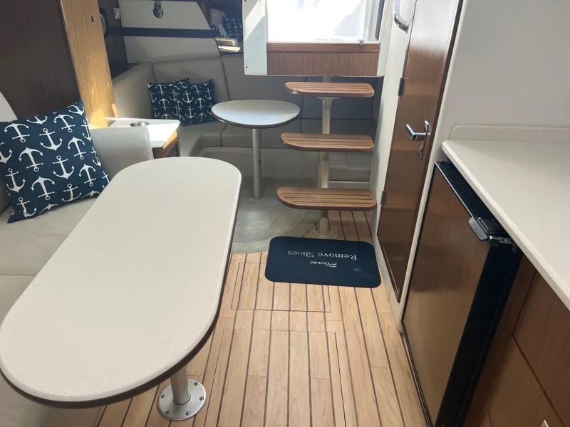 Slide: The Image of Interior of 2015 Cruisers Yachts 350 Express with modern seating and wooden flooring. - 19