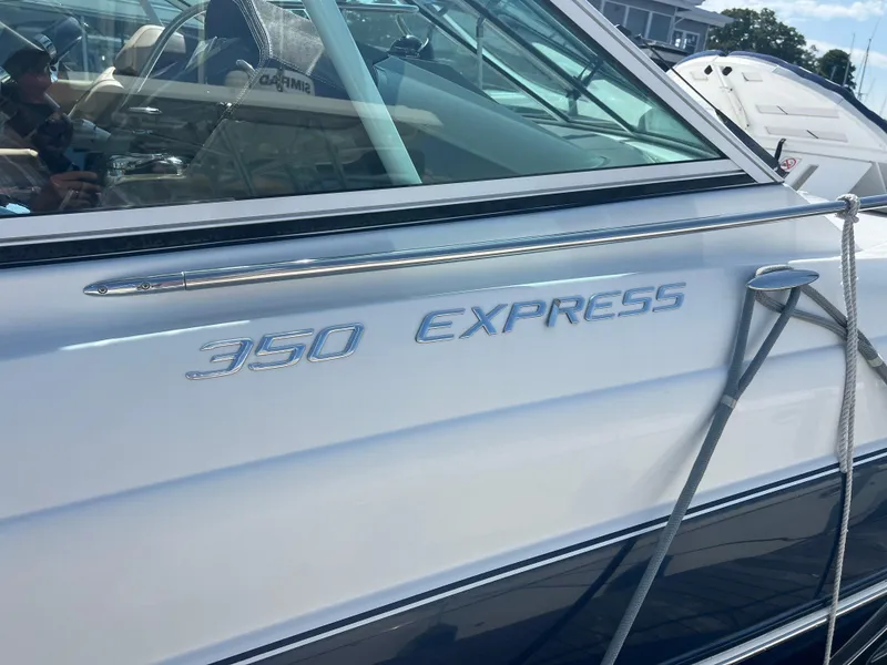 Slide: The Image of 2015 Cruisers Yachts 350 Express boat docked with visible branding. - 21