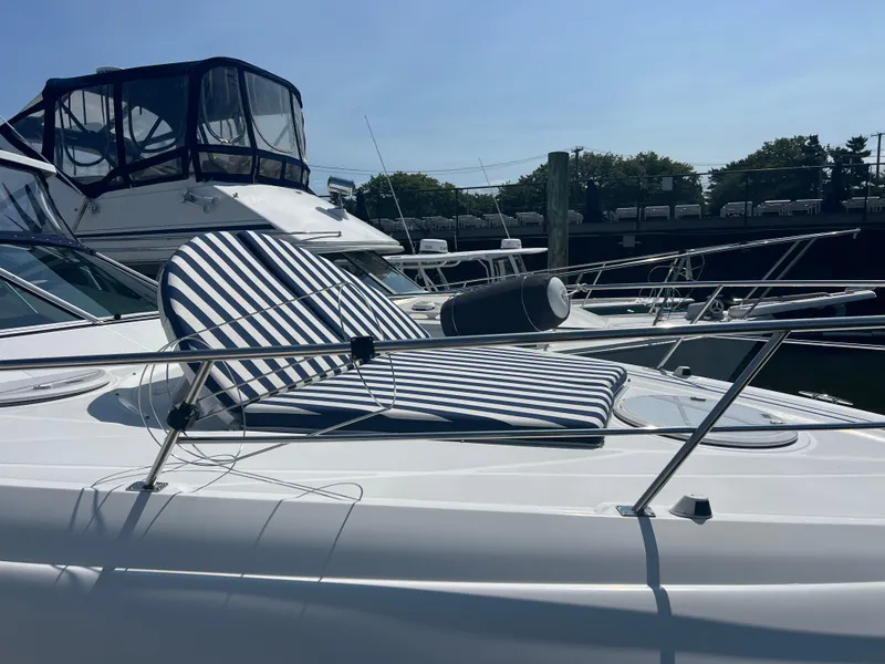 Slide: The Image of 2015 Cruisers Yachts 350 Express with striped deck chair, docked in marina. - 22