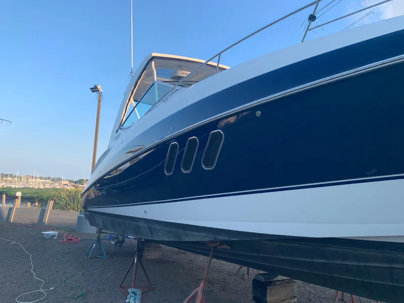 Slide: The Image of 2015 Cruisers Yachts 350 Express on dry dock, side view. - 3