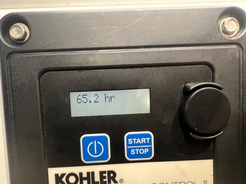 Slide: The Image of Kohler control panel displaying 68.2 hours on a 2015 Cruisers Yachts 350 Express. - 5