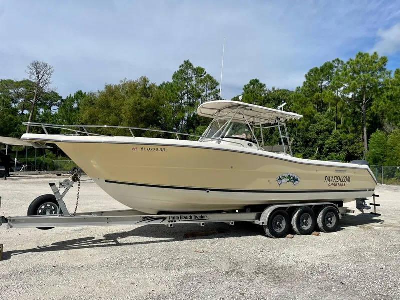 Slide: The Image of 2006 Pursuit 3070 Center Console boat on trailer, parked outdoors. - 1