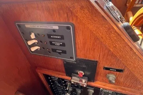 Slide: The Image of 1980 Grand Banks 32 Flybridge Trawler control panel with switches and horn button. - 10