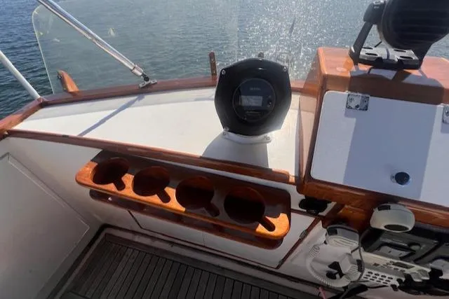 Slide: The Image of 1980 Grand Banks 32 Flybridge Trawler helm with wooden cup holders and navigation equipment. - 17